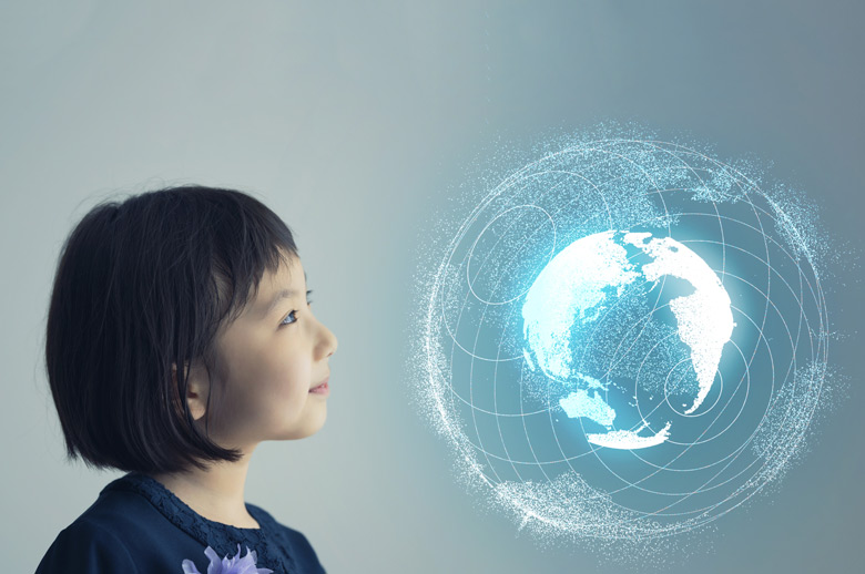 Stock photo of an Asian girl on a gray-blue background looking at a virtual globe.